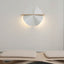 Unfolded wall lamp with lights on, placed above a daybed