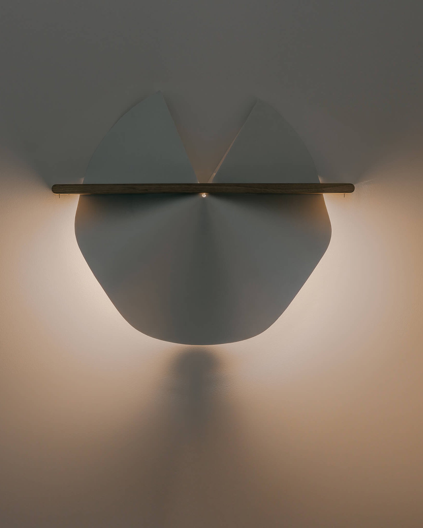 Dawn wall lamp in washi paper and oak and light on, styled on wall by Motarasu
