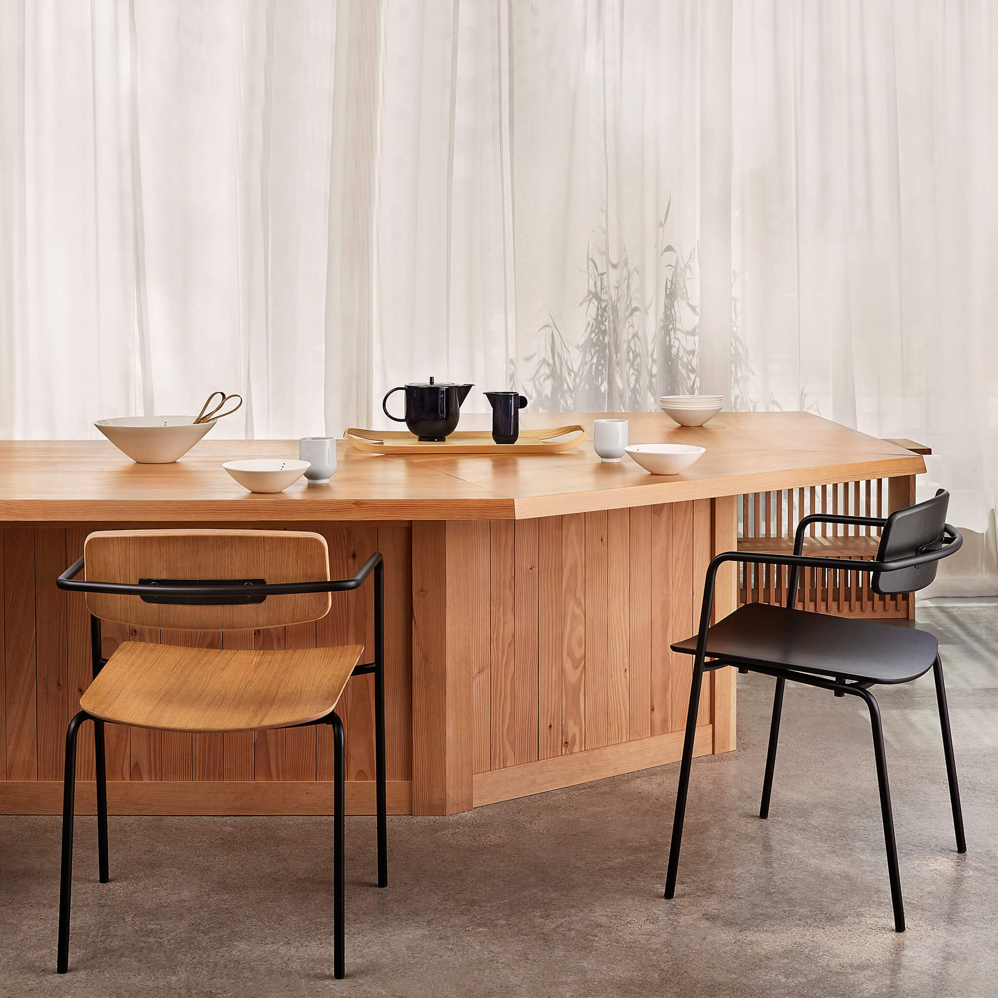 Set of two dining chairs with open back in a restaurant