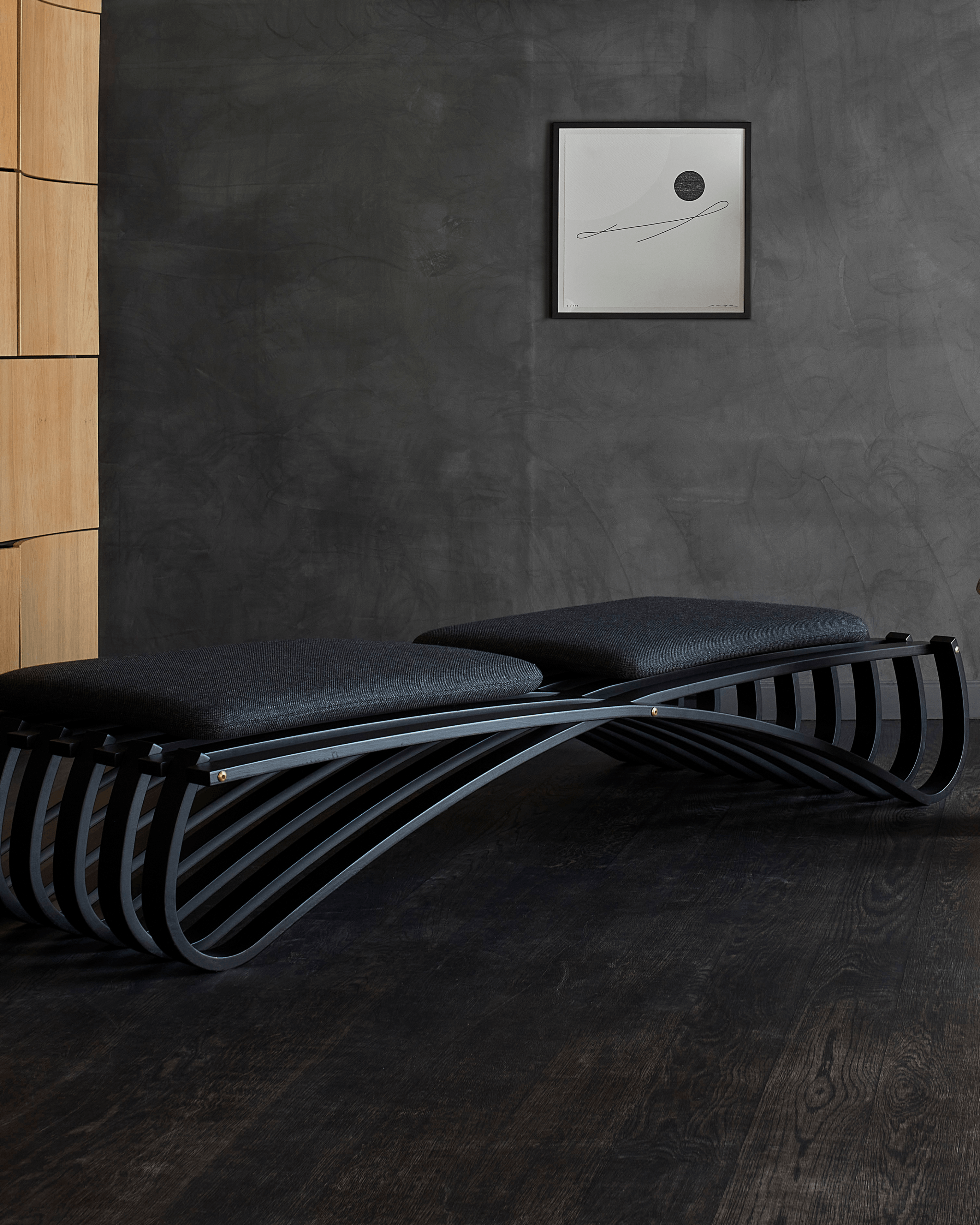 Jundo daybed in black matt beech veneer, close-up of ribbed structure and brass fittings in dark interior by Motarasu