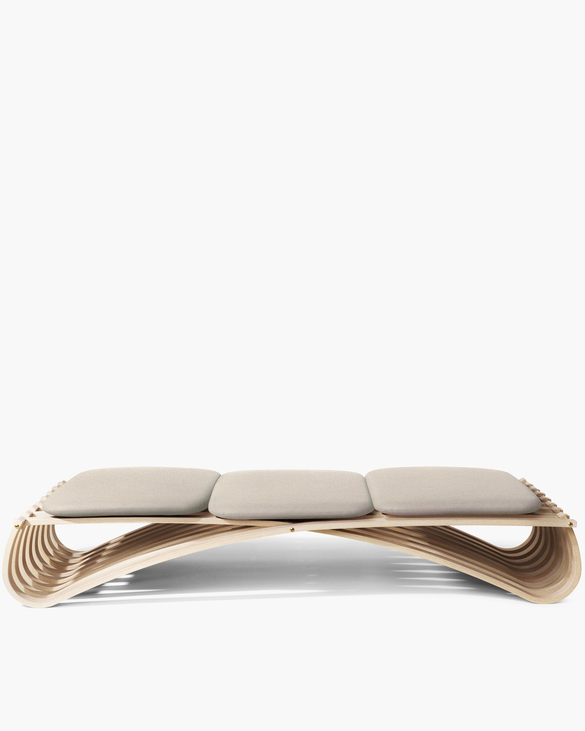 A modern three-seat daybed with a curved, layered wooden frame and three light beige cushions, shown against a plain white background.