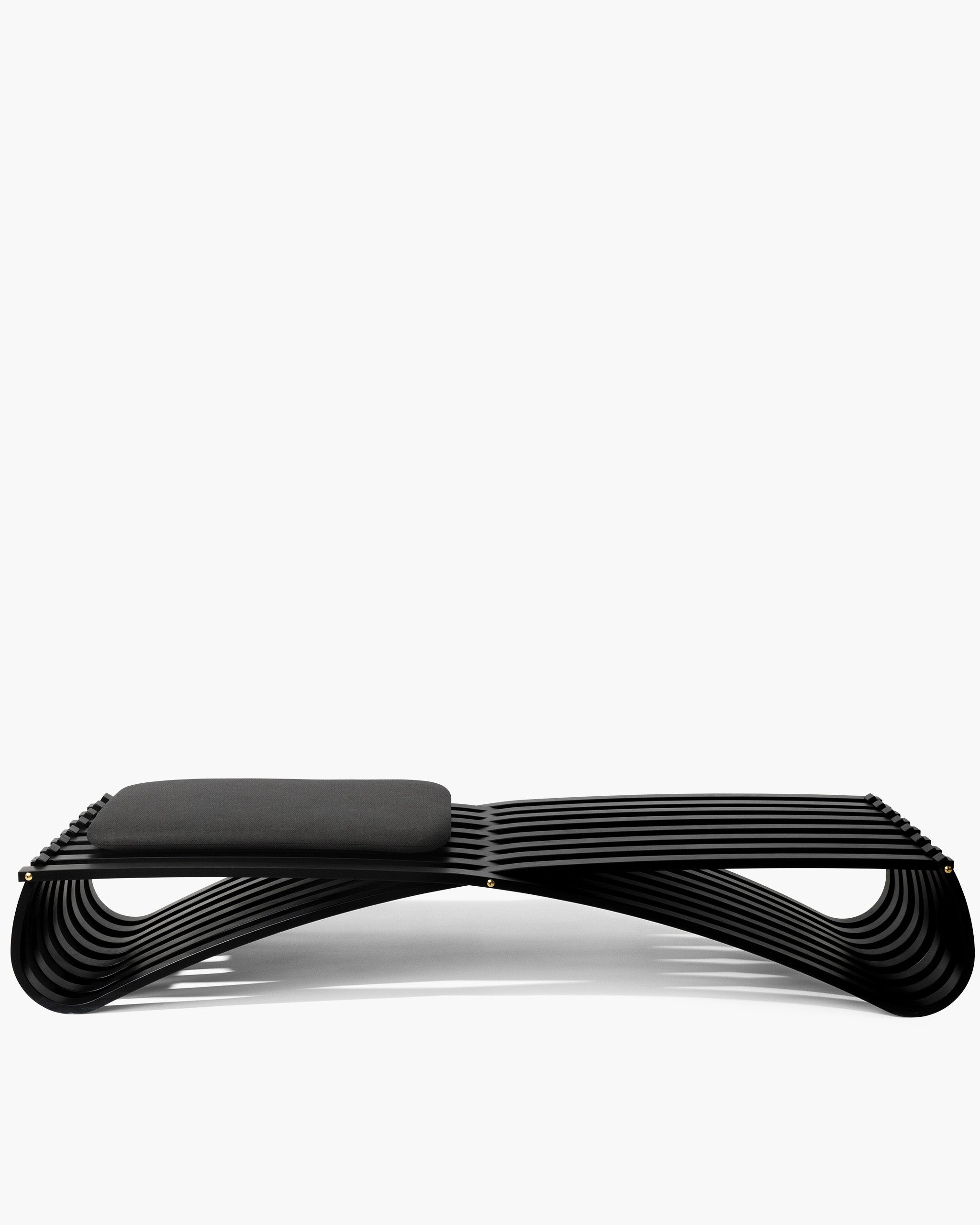Sculptural Jundo daybed / Bench in black matt beech veneer and one beige cushion, full silhouette on white background by Motarasu