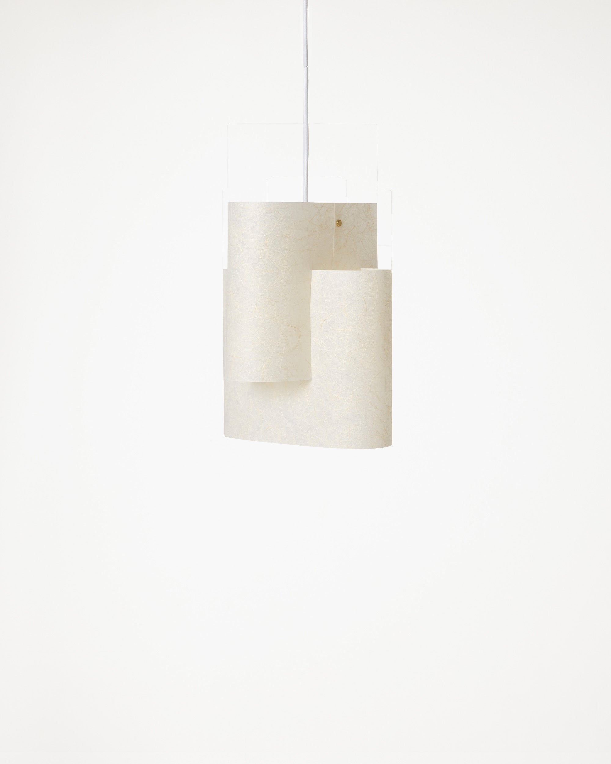 A modern pendant light with a sculptural, layered cylindrical shade made of textured off-white washi paper, suspended by a thin white cord against a solid white background.