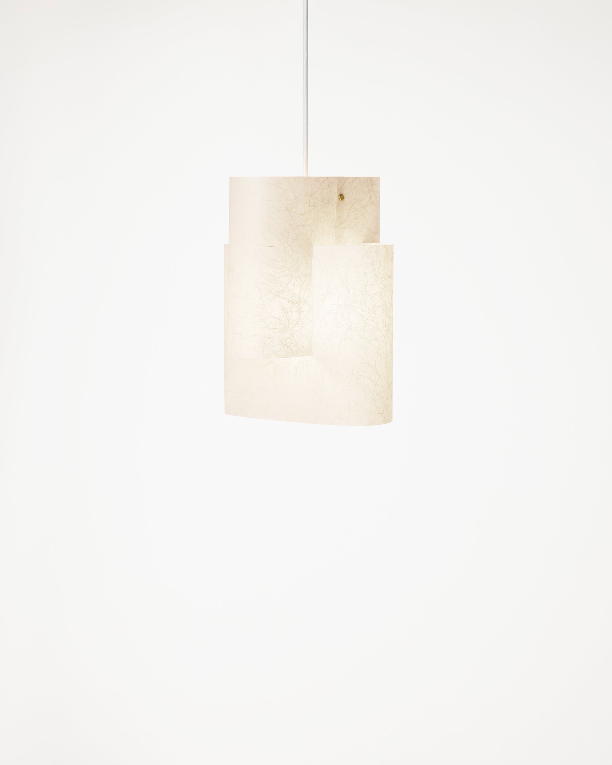 Close-up of the soft textured washi paper on the Sekiun Raw pendant, fibre grain visible when lit