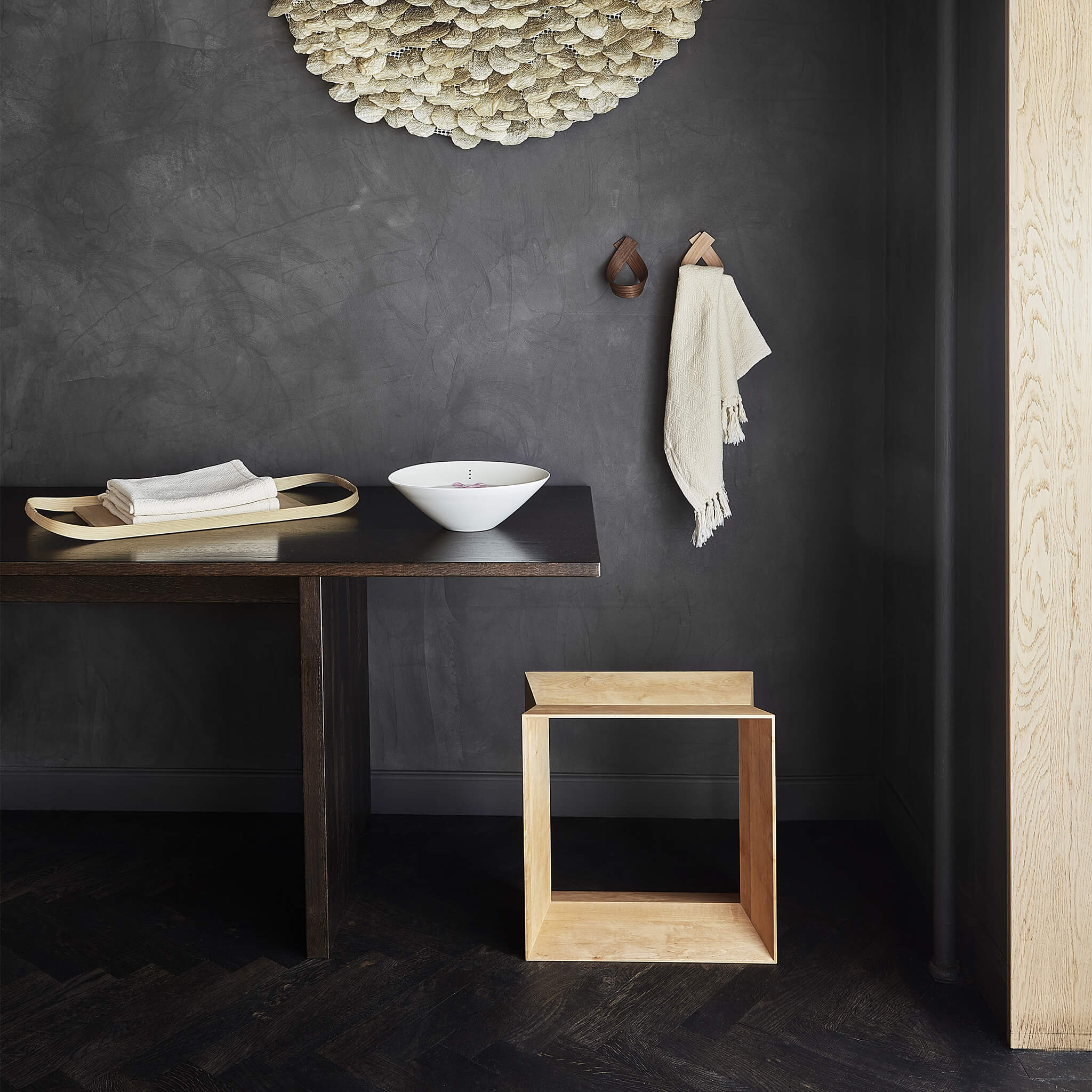Light brown oak stool placed next to a dining table