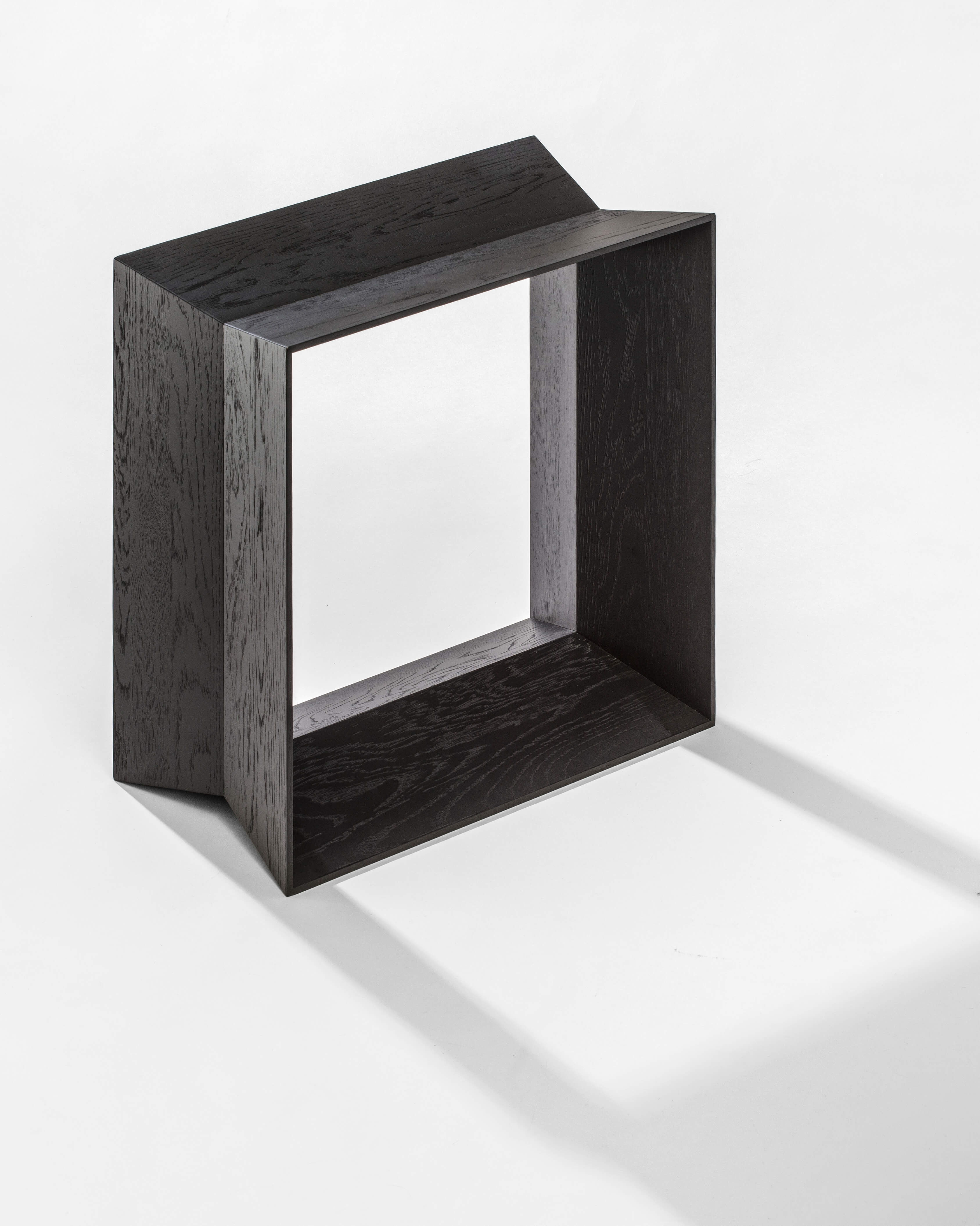 Reflex stool in black stained solid oak, side view on white background by Motarasu