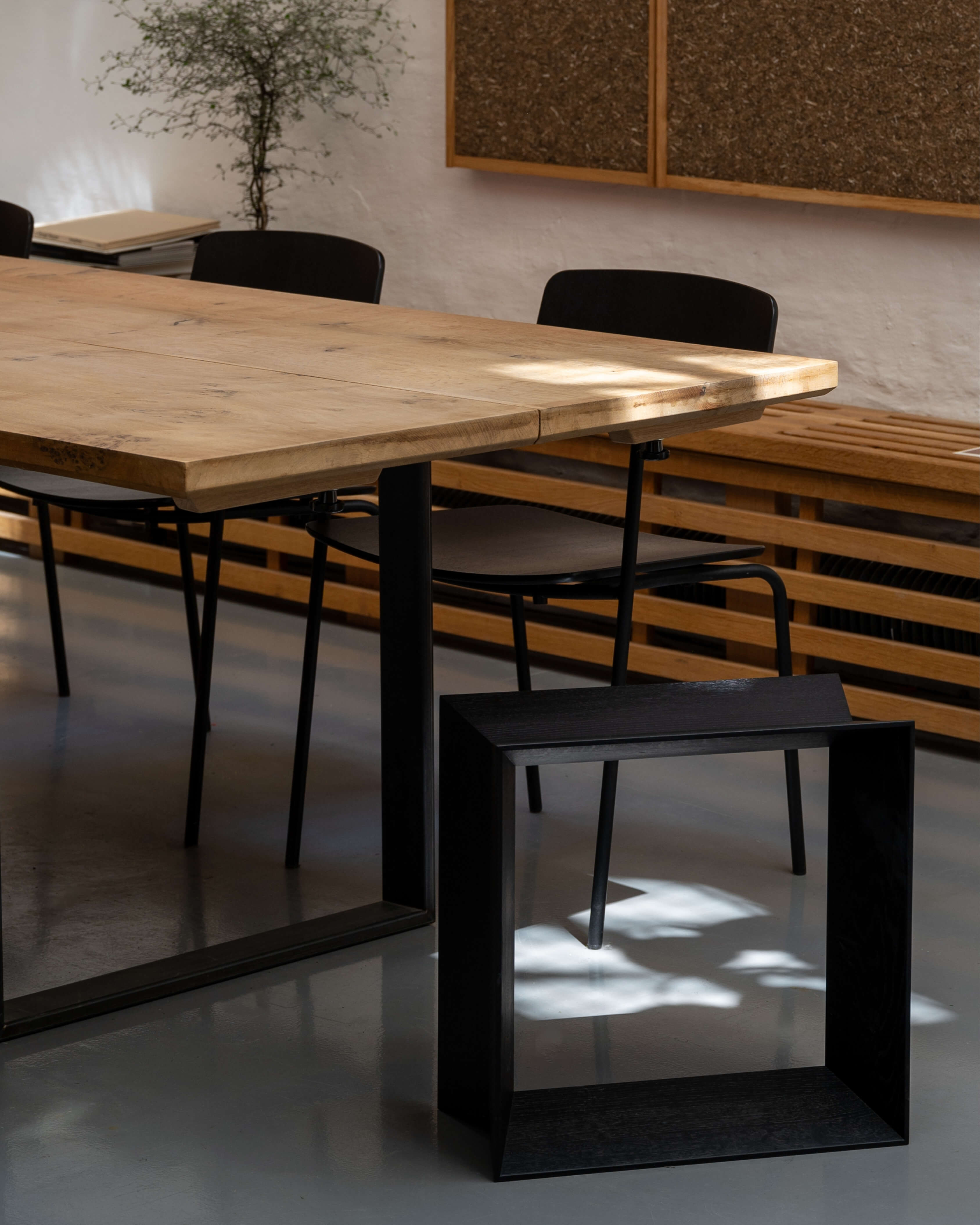 Reflex stool in black stained solid oak, styled in a dining interior next to table and chairs by Motarasu