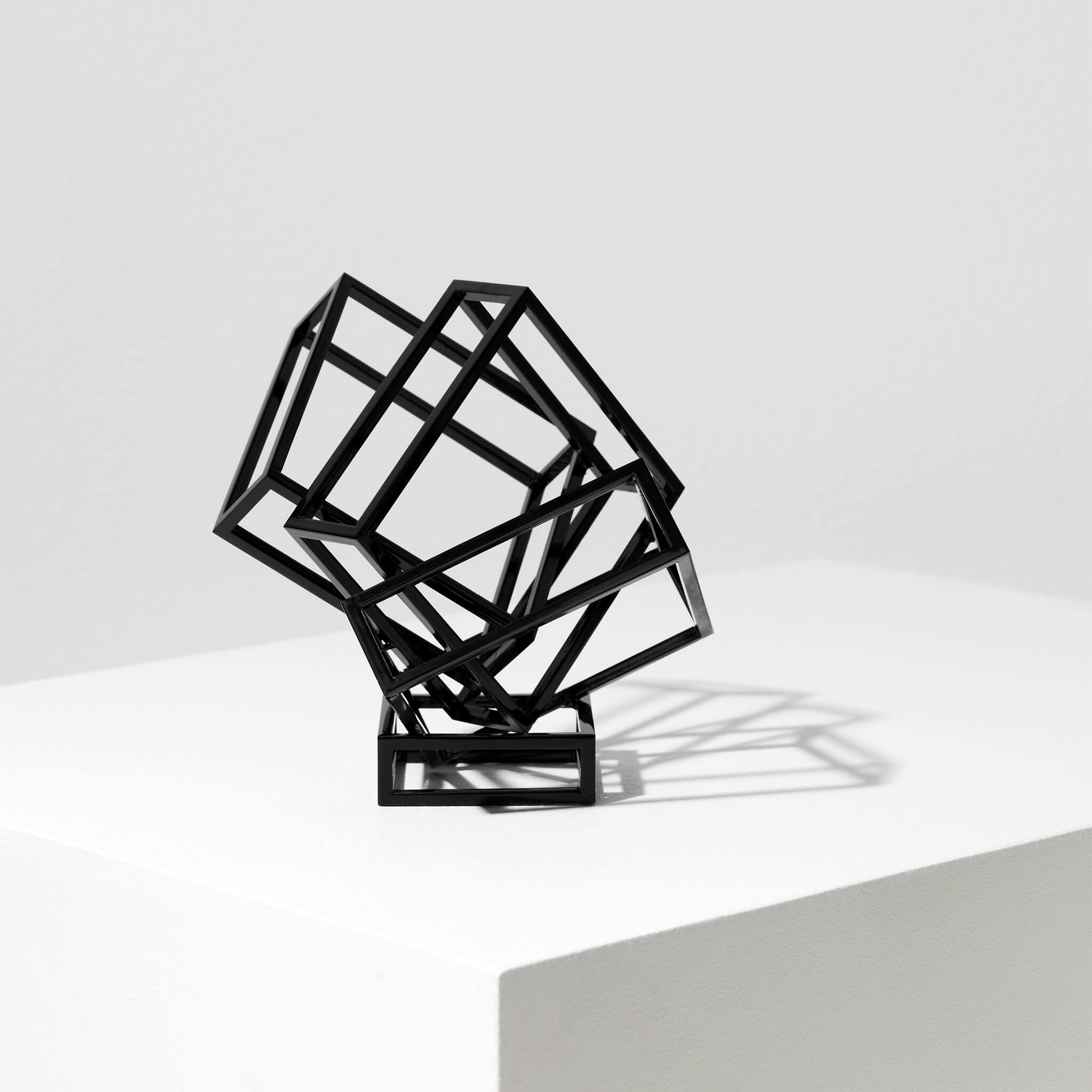 Black coated steel sculpture on a flat surface