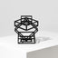 Steel sculpture on a flat surface, against a white background