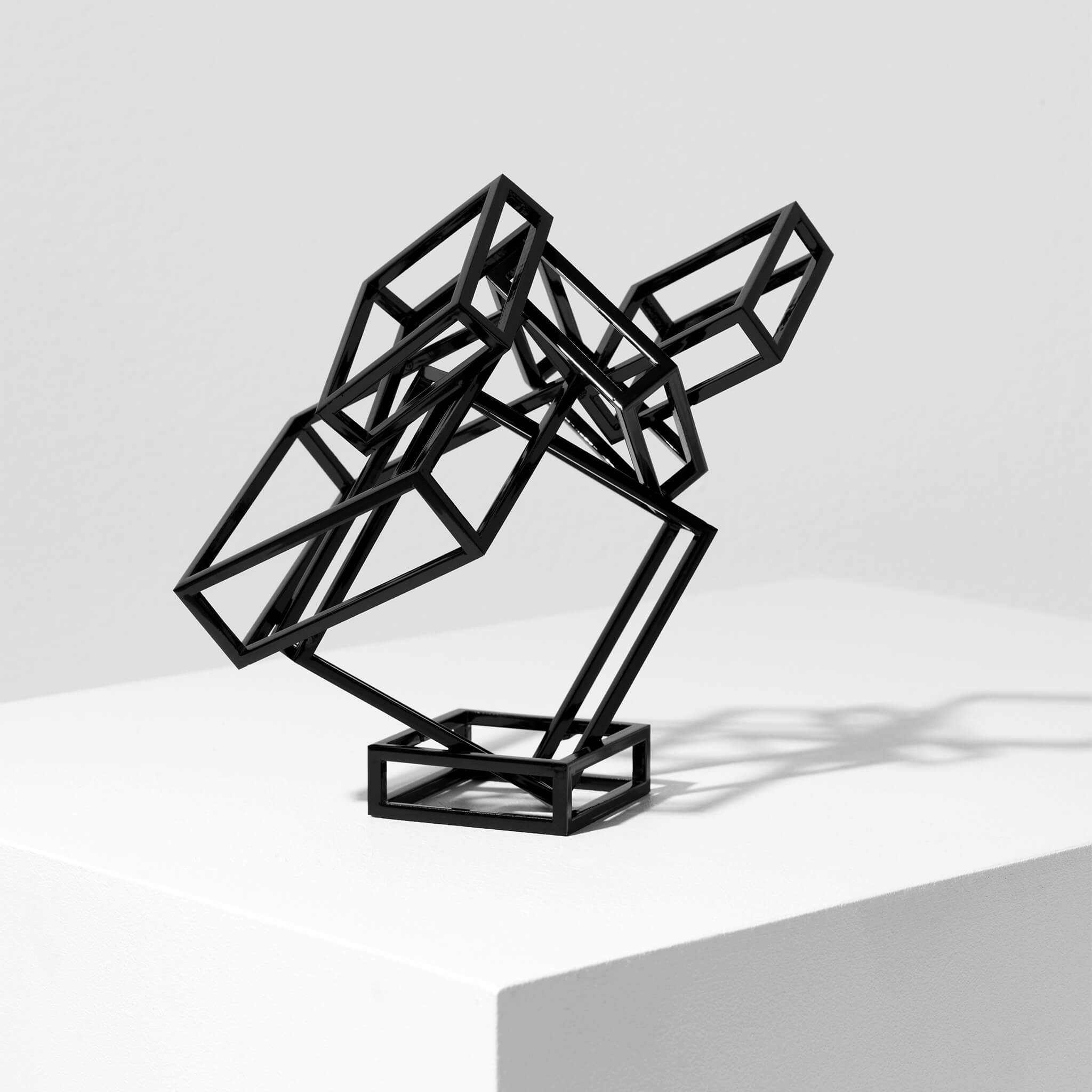 Black coated steel sculpture against a white background