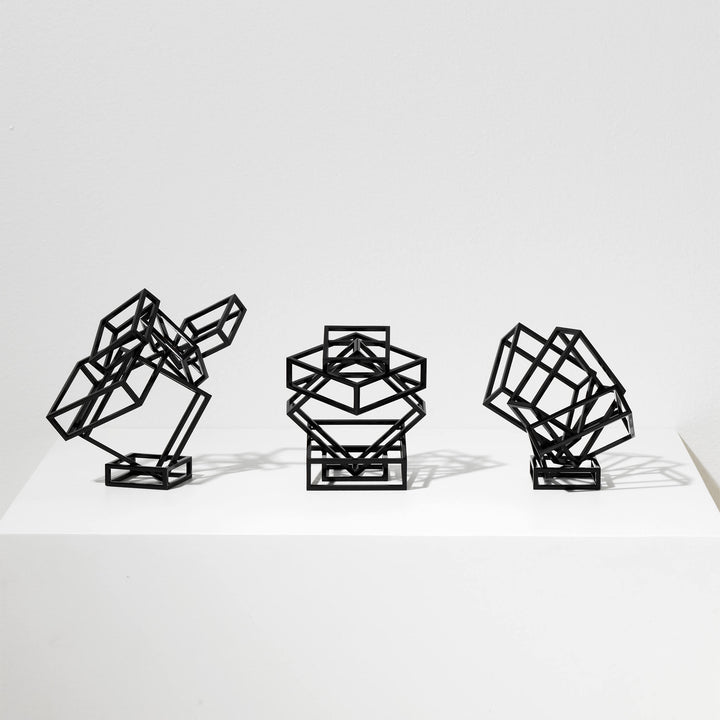 Collection of three steel sculptures coated in black