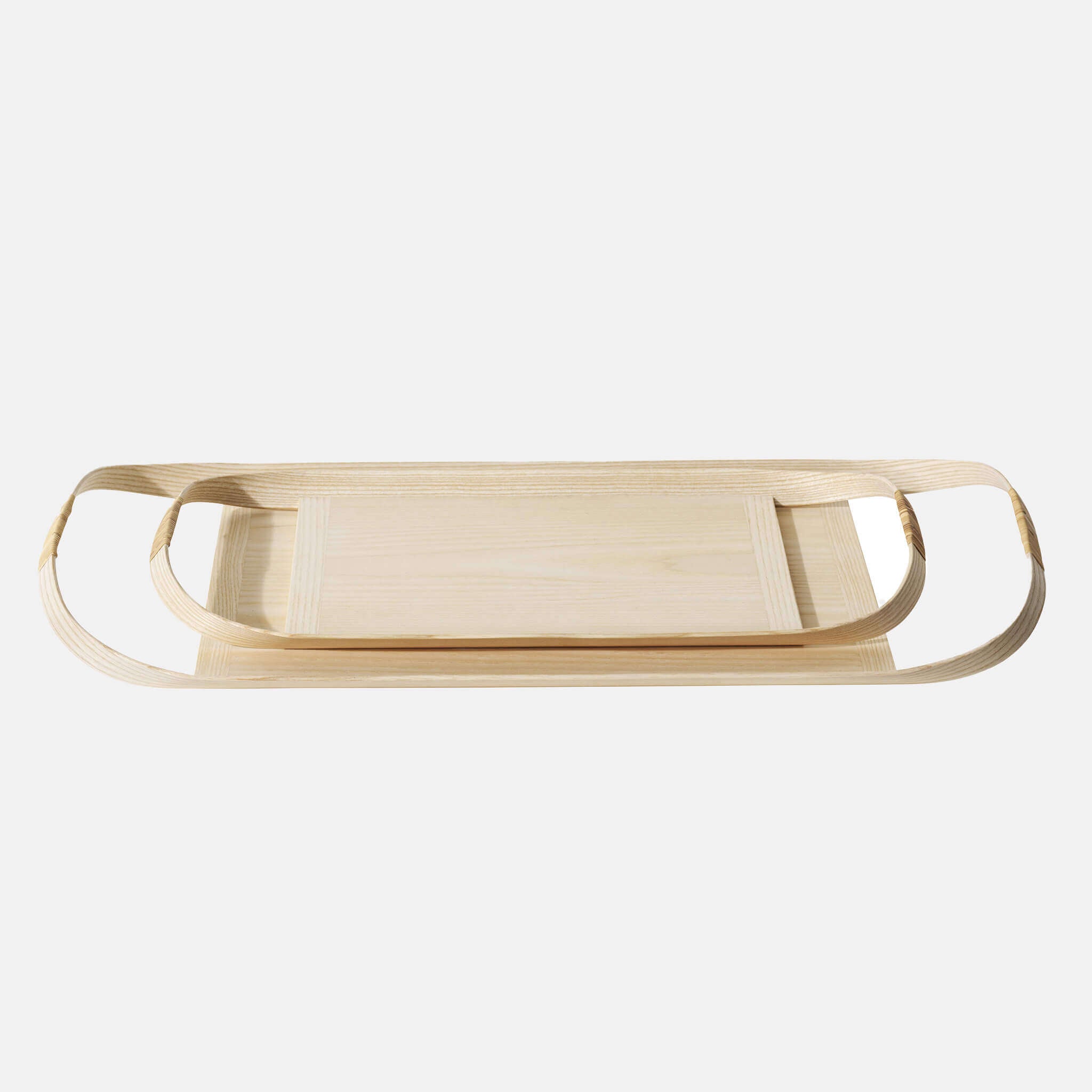 Small wooden tray placed on top of large wooden tray