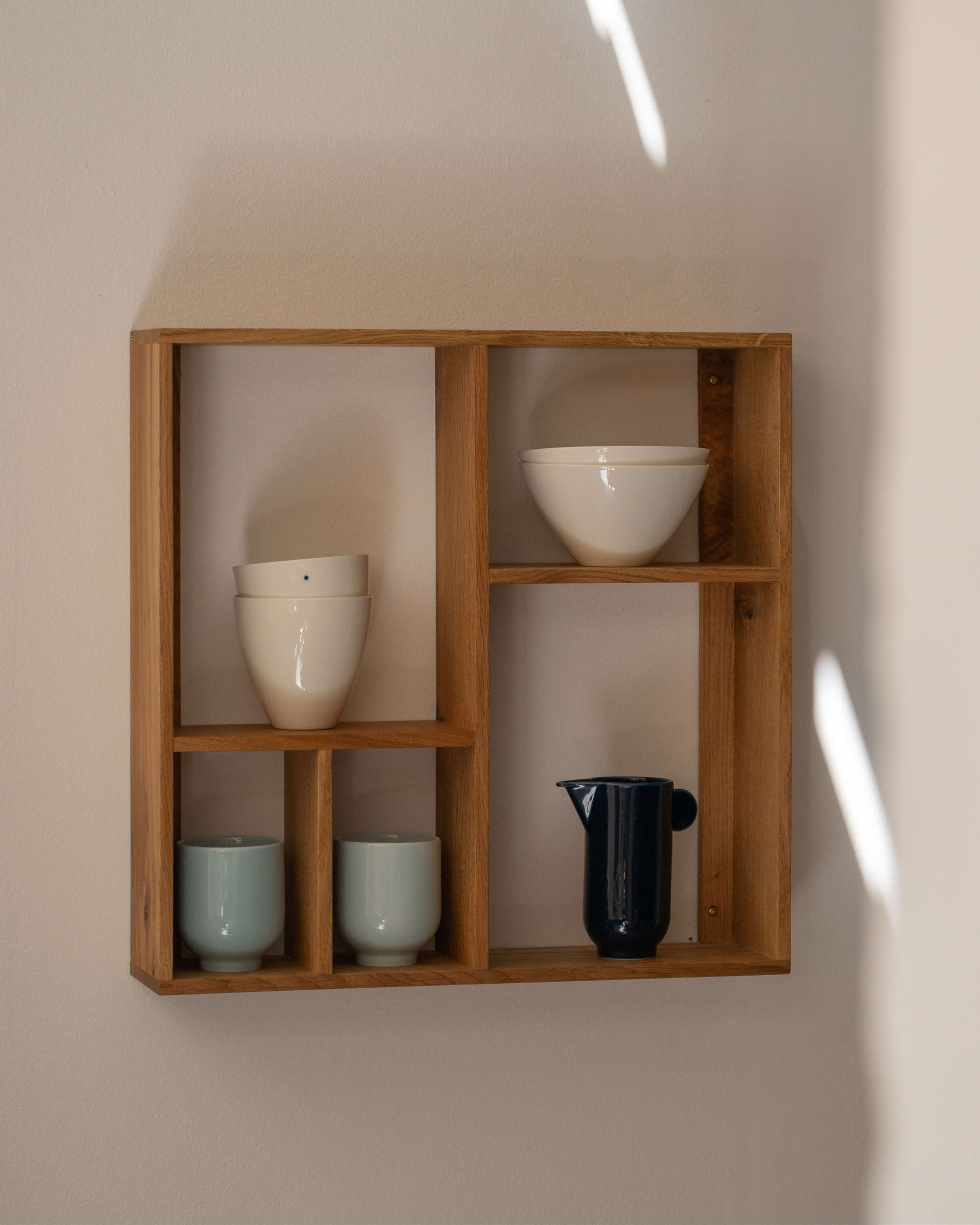 Yoko pitcher in porcelain, styled with Yoko collection on a wooden tray by Motarasu