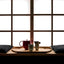 Porcelain tea set arranged on a wooden tray in a dark room