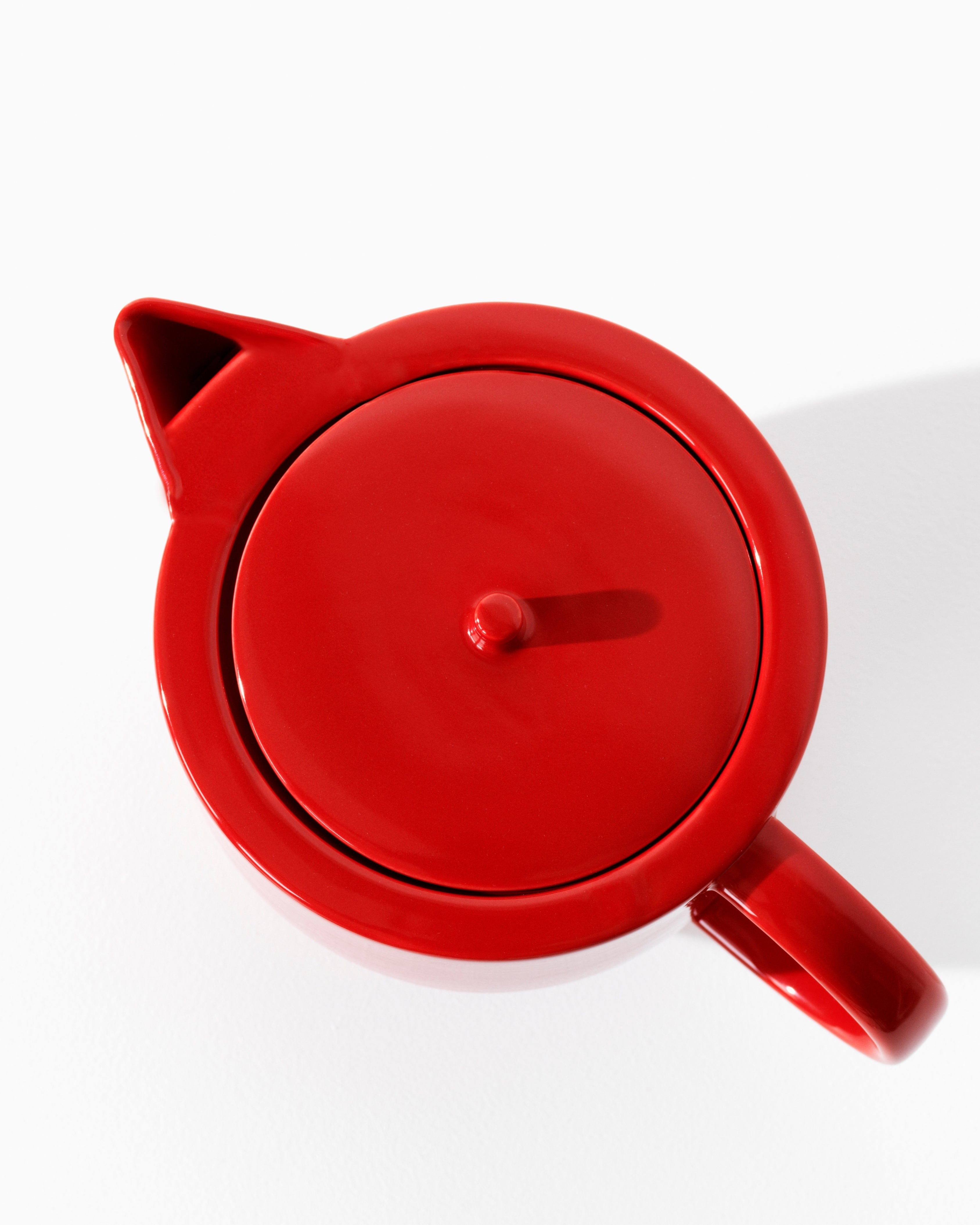 Yoko teapot in red porcelain, full silhouette on white background by Motarasu