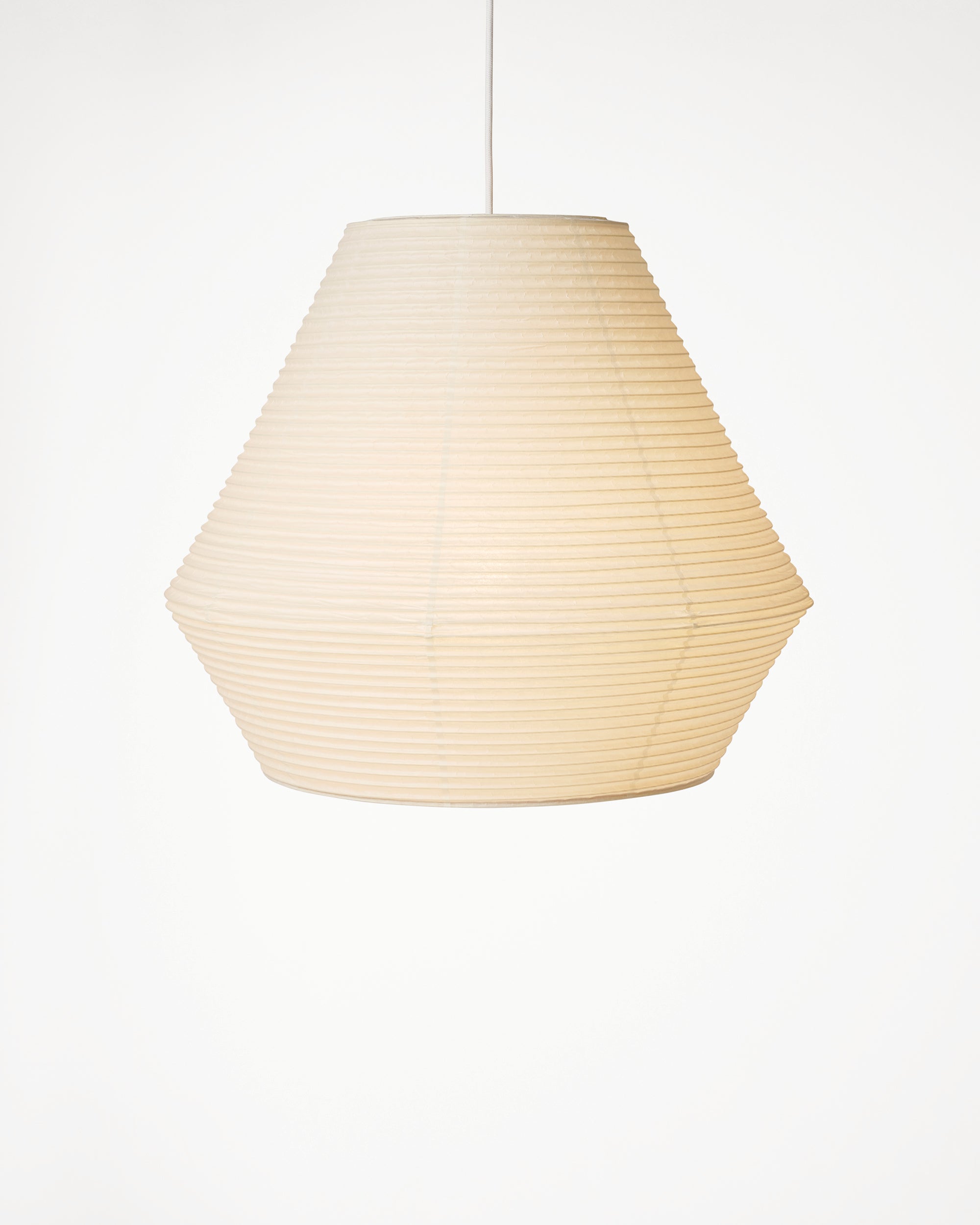 Tsumugi A pendant in washi paper with handcrafted bamboo structure and light on, on white background by Motarasu
