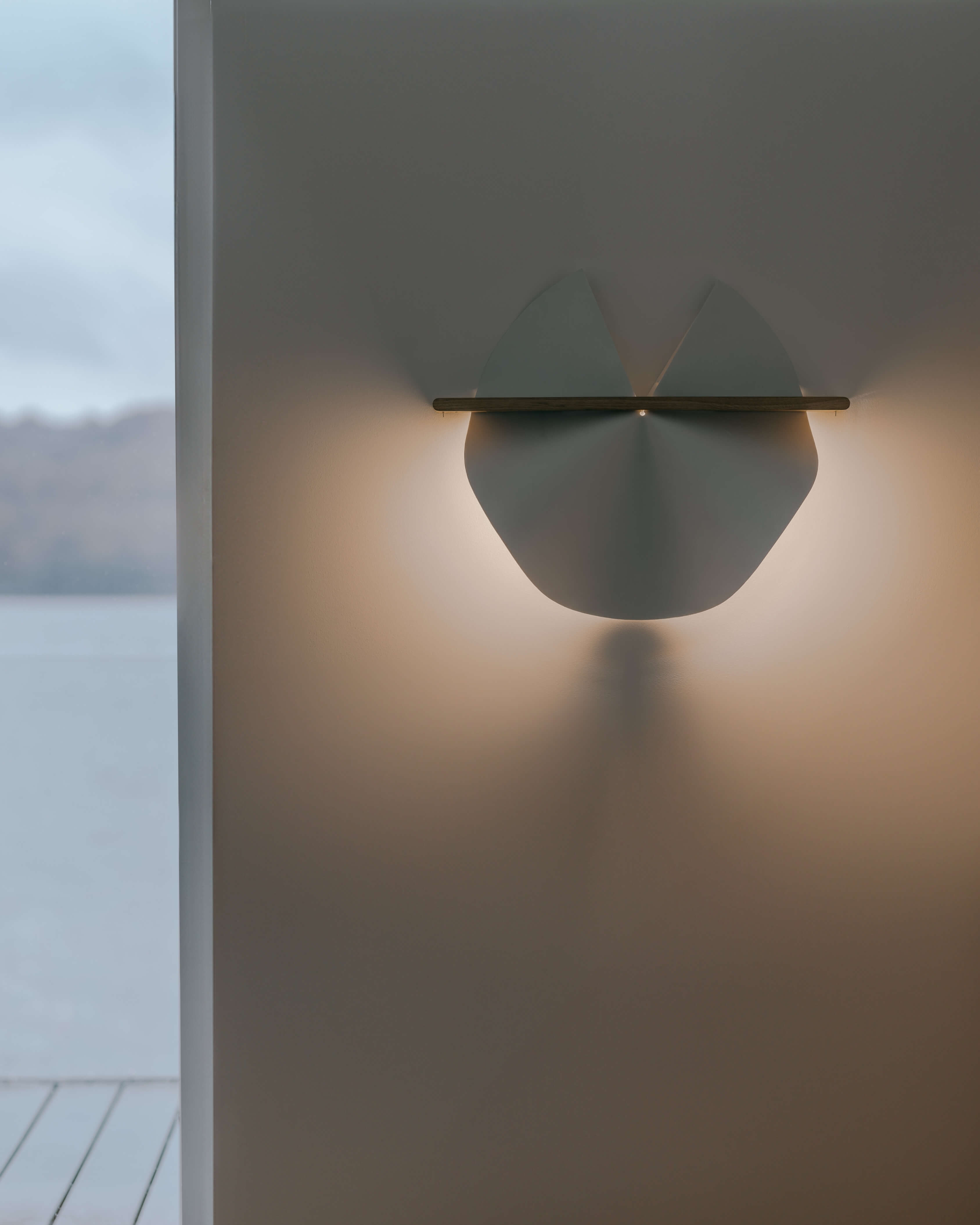 Dawn wall lamp in washi paper and oak, mounted on wall in warm interior by Motarasu