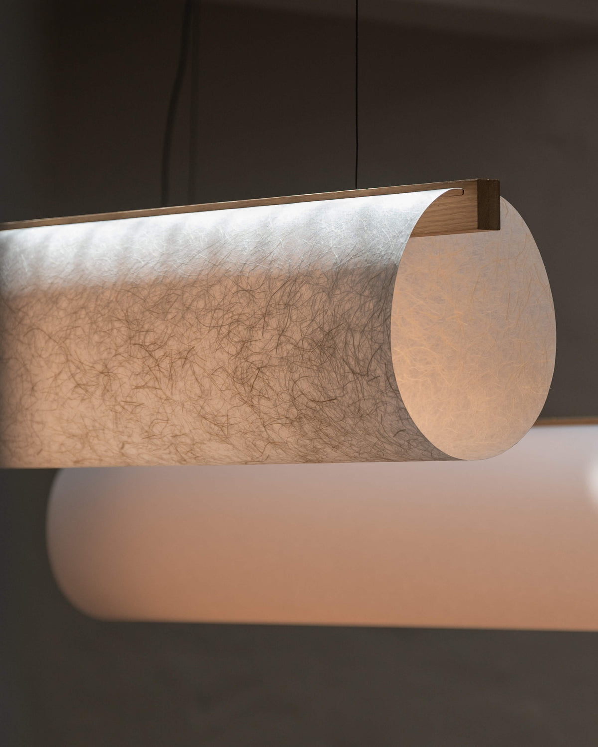 Enso Raw pendant, close-up of washi paper shade with warm light and oak joinery detail by Motarasu