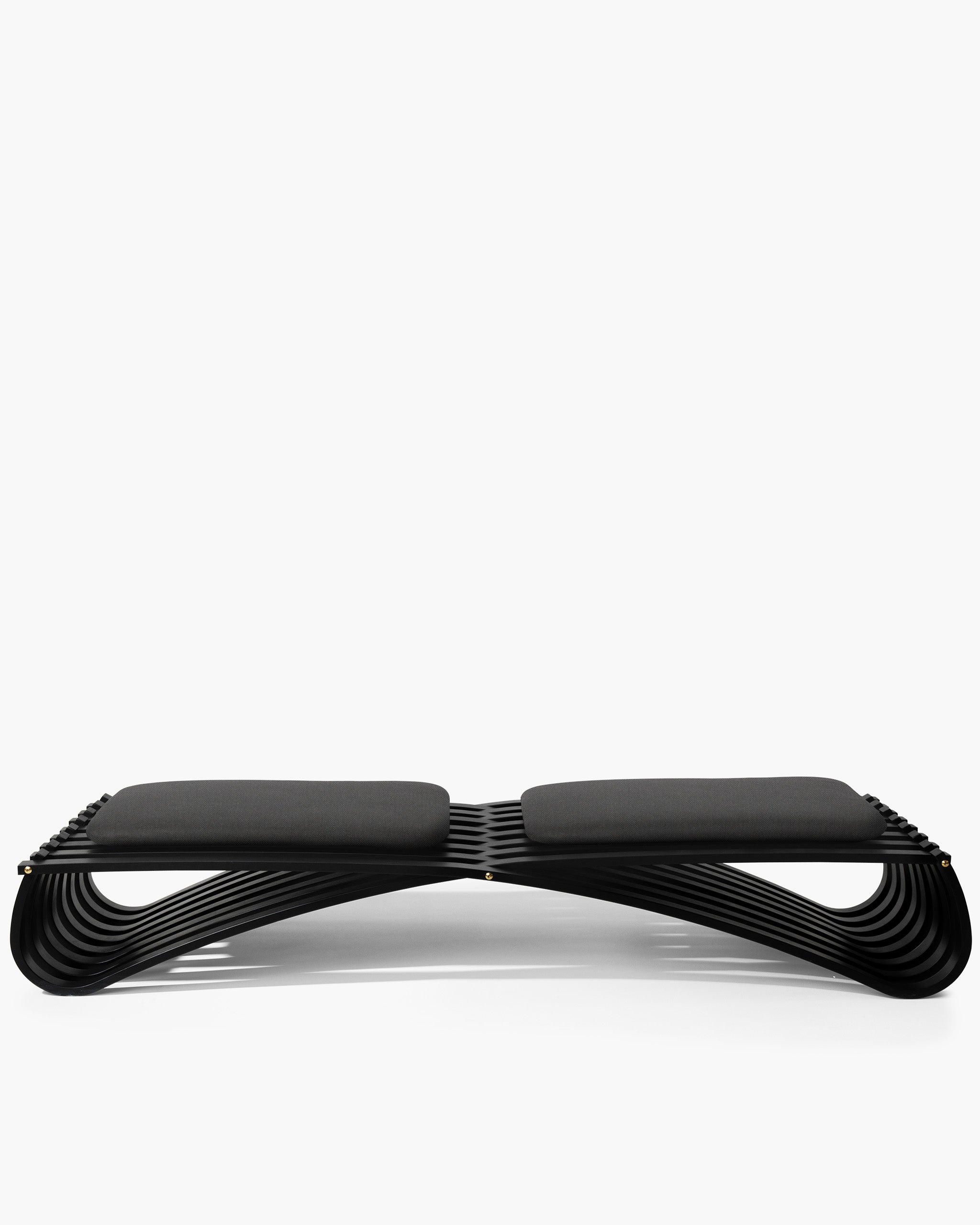 Jundo daybed in black matt beech veneer with two black cushions, side view on white background by Motarasu