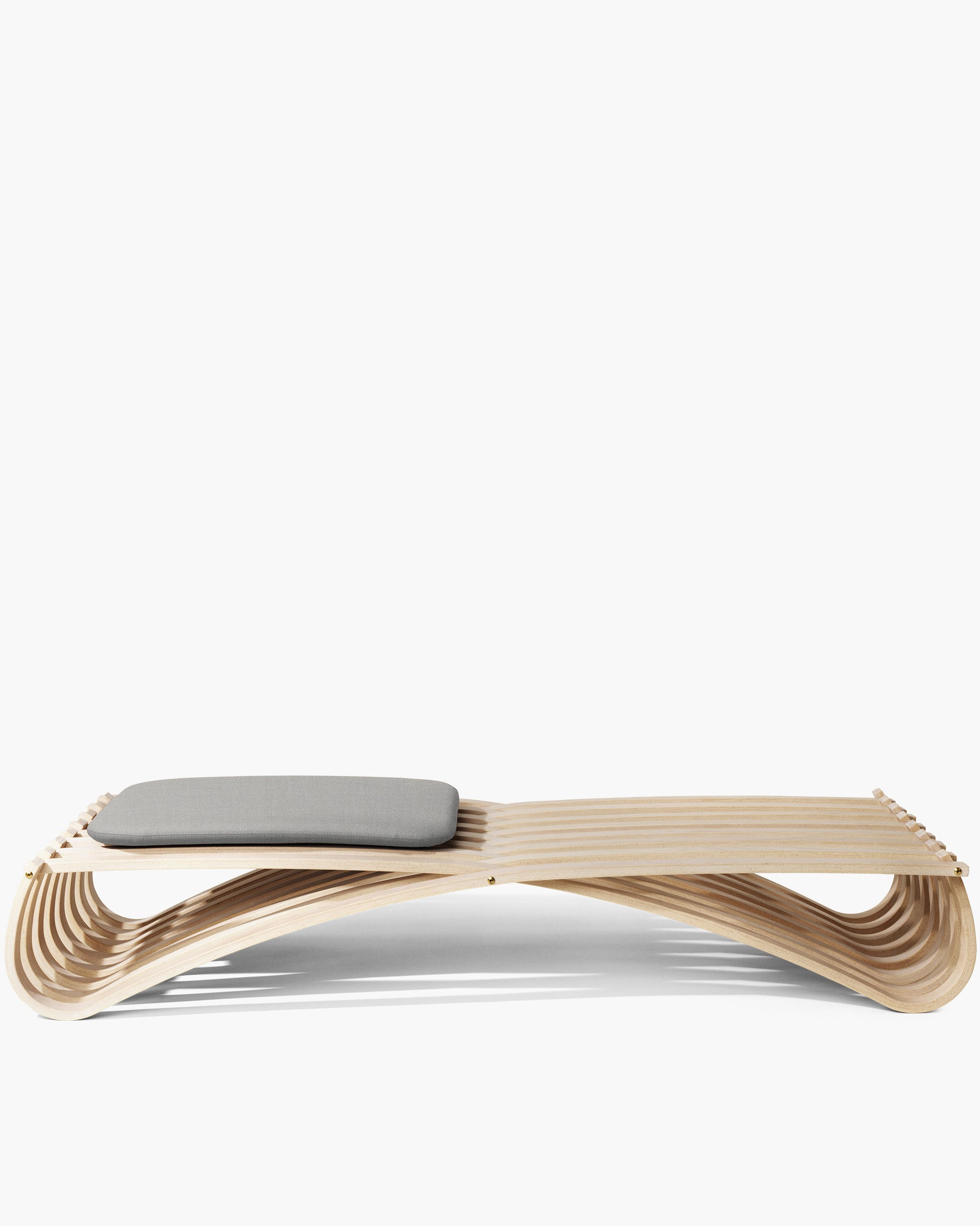Sculptural Jundo daybed in white-oiled beech veneer with one grey cushions, on white background by Motarasu