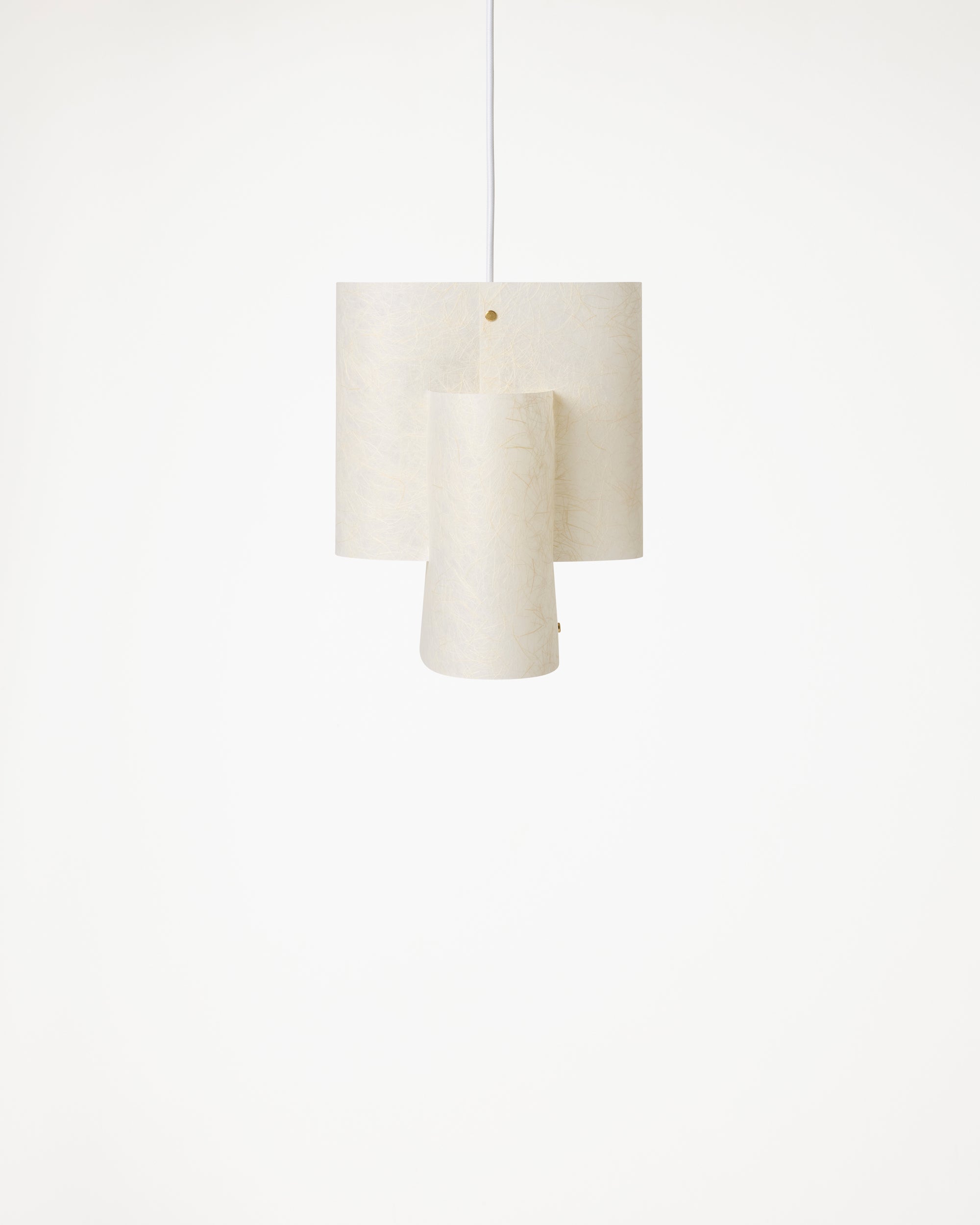A modern three-tiered pendant light with cylindrical shades in a textured off-white fabric, suspended by a thin white cord 