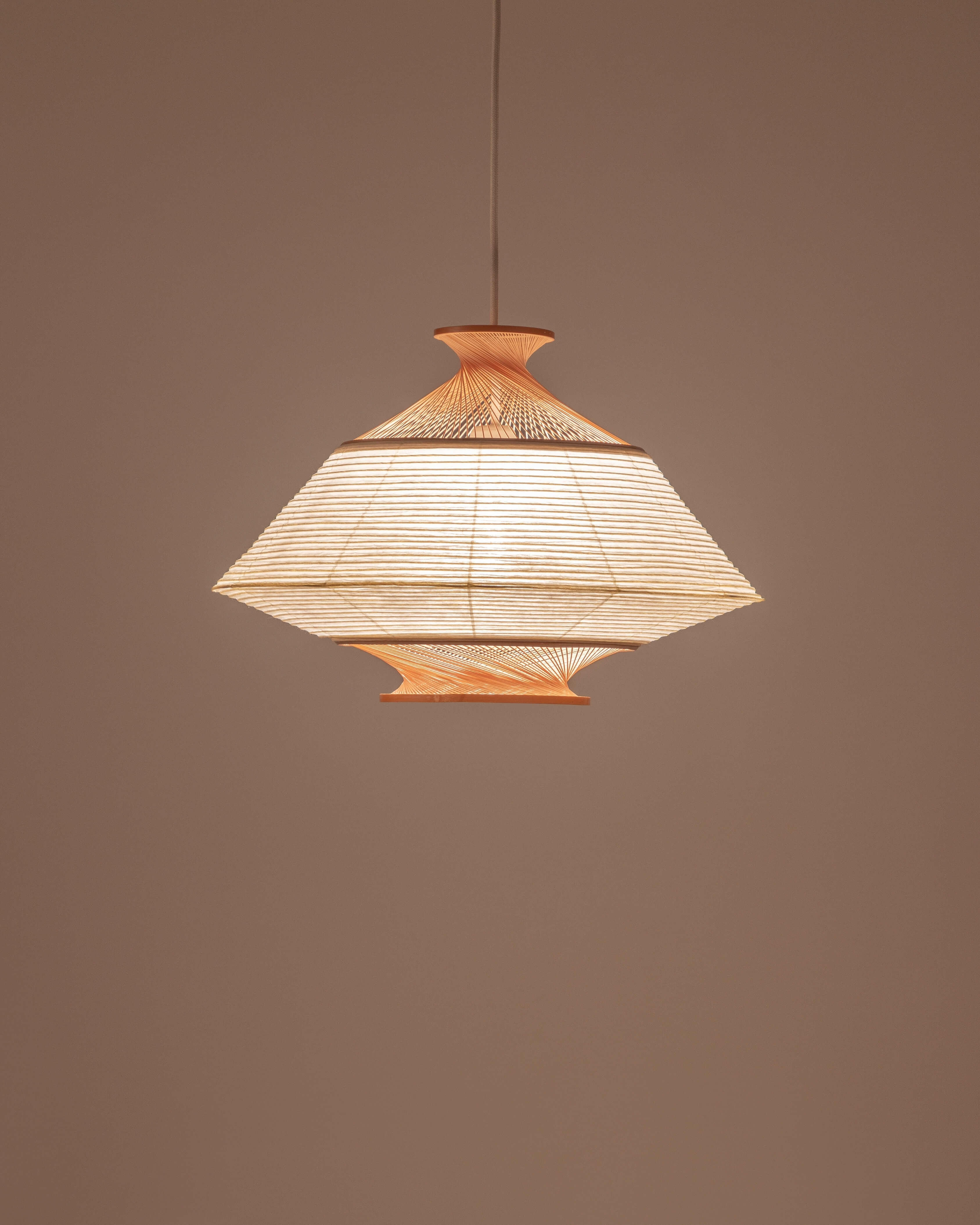 Ron pendant in washi paper and Hiba wood with light on, shade turned upside down showing inverted silhouette by Motarasu