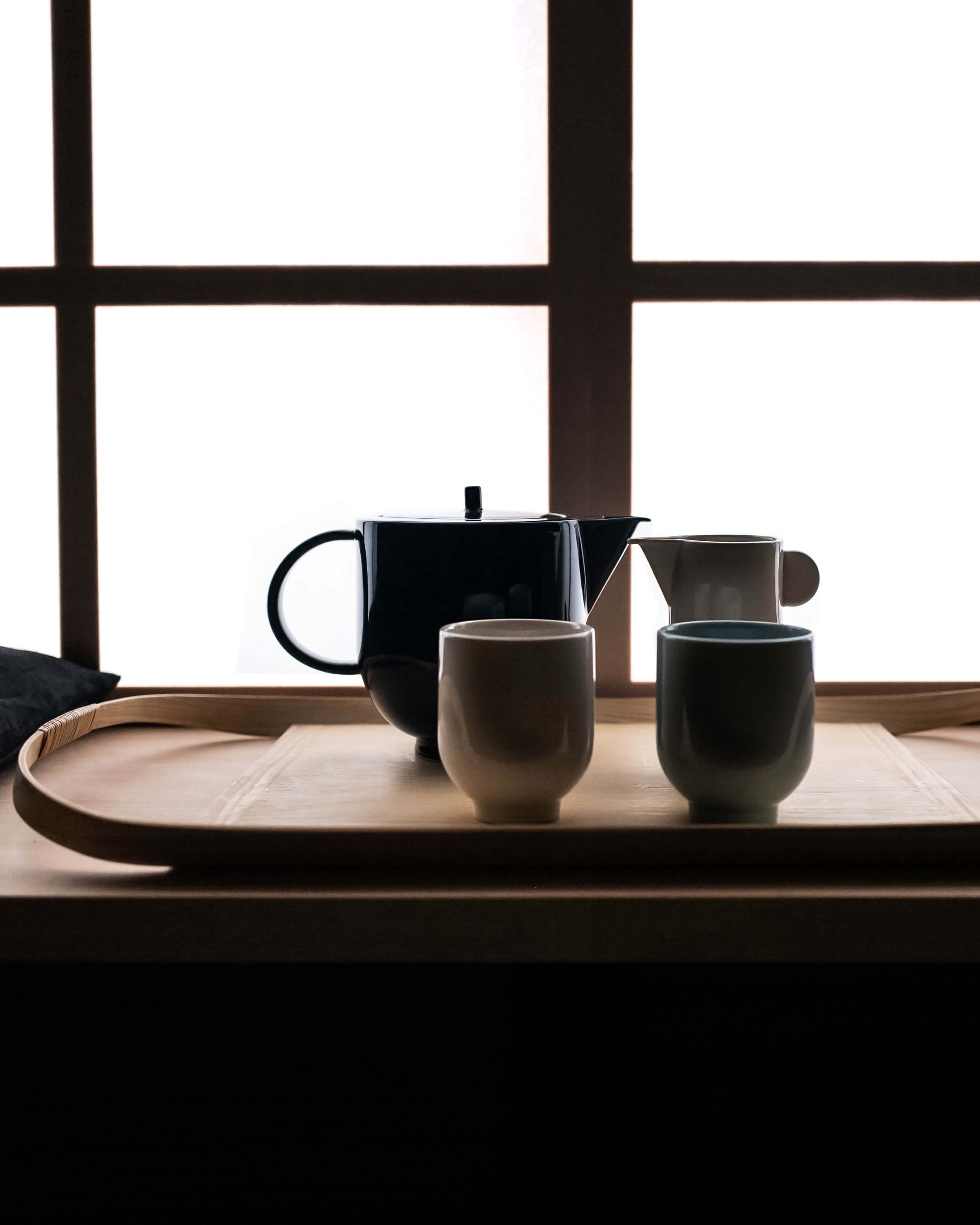 Yoko pitcher in porcelain, styled with Yoko mugs and teapot in a dark japanese table setting by Motarasu